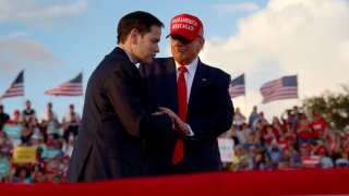 Former U.S. President Donald Trump stands with Sen. Marco Rubio.