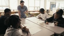 Math teacher Josh Weisbard tutors four Johnson Middle School students.