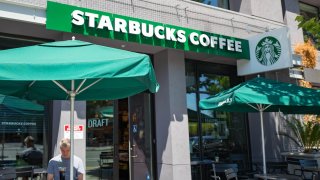 A man works outdoors at a Starbucks Coffee cafe