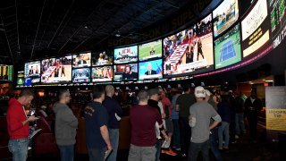 Guests line up to place bets at a viewing party for the NCAA Men's College Basketball Tournament in 2018 in Las Vegas.