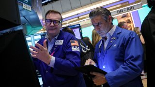 Traders work on the floor at the New York Stock Exchange (NYSE) in New York City, U.S.