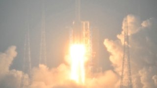 A Long March 5 rocket, carrying the Chang’e-6 mission lunar probe, lifts off as it rains at the Wenchang Space Launch Centre in southern China’s Hainan Province on May 3, 2024. 