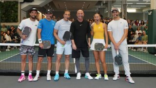 (L-R) Tyson McGuffin, Collin Johns, Life Time Founder and CEO Bahram Akradi, Andre Agassi, Anna Bright and Ben Johns pose for a photo at the new Life Time at Penn 1 next to Madison Square Garden in New York City on May 4, 2024.