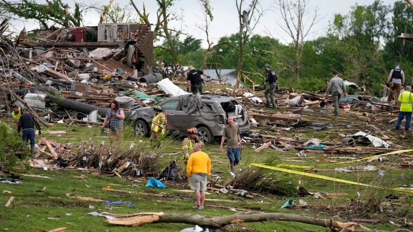 Workers search through the remains of tornado-damaged homes, Tuesday, May 21, 2024, in Greenfield, Iowa.