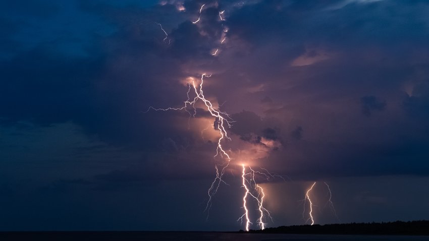 Fiile. Dramatic lightning thundertbolt bolt strikes at night, bad weather,dark sky