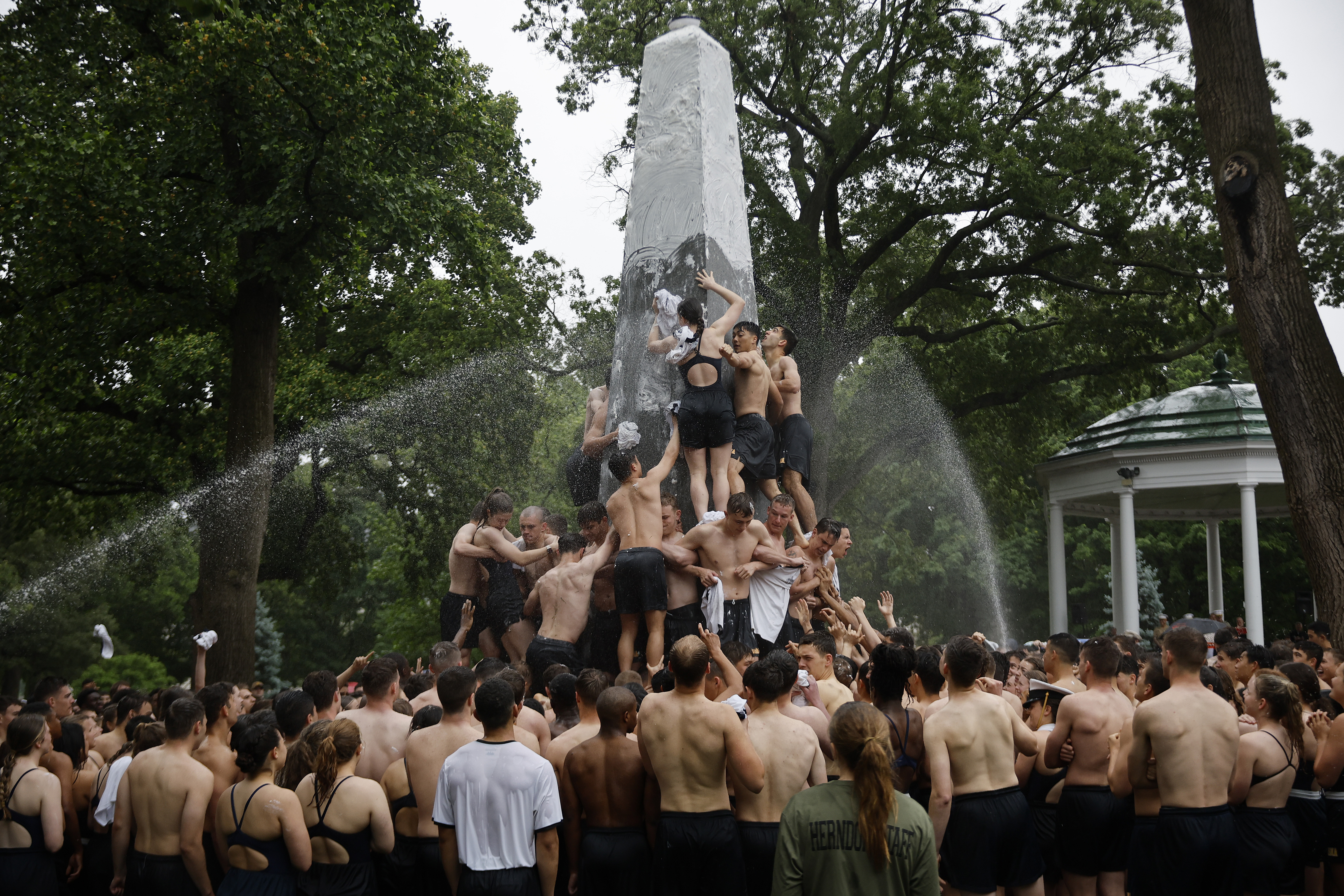 Photos: Plebes continue tradition, scale greased 21-foot monument