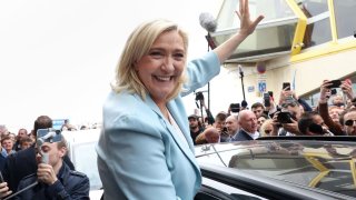 Marine Le Pen, French far-right National Rally (Rassemblement National) party candidate for the 2022 French presidential election, waves to supporters as she leaves after a visit in Berck-sur-Mer on the last day of campaigning, ahead of the second round of the presidential election, France, April 22, 2022.