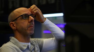 A stock broker of the Frankfurt stock exchange looks at his screens in Frankfurt, Germany, March 16, 2023. 