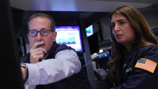 Traders work on the floor at the New York Stock Exchange.
