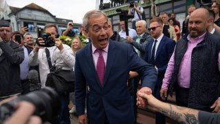 Reform UK party leader Nigel Farage walks to speak to supporters as he launches his election candidacy at Clacton Pier on June 4, 2024 in Clacton-on-Sea, England.
