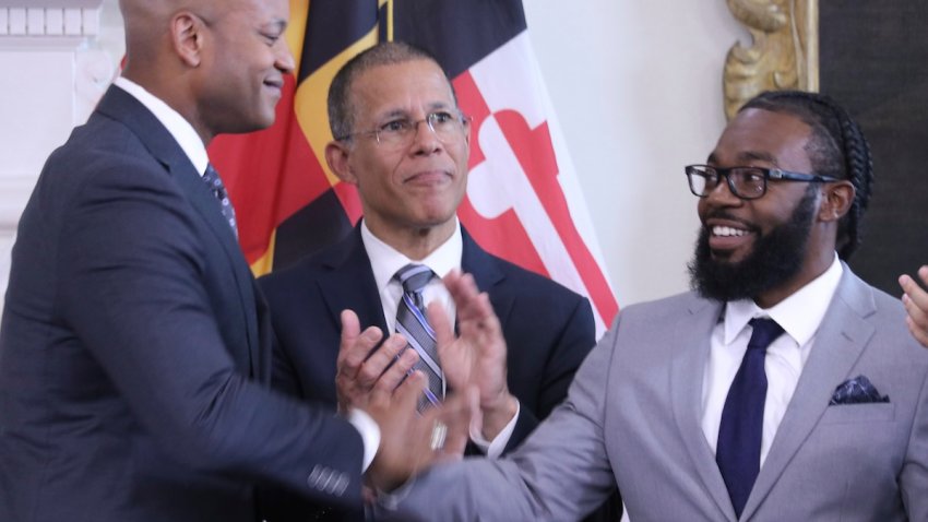 Shiloh Jordan, right, who was among the people receiving a pardon for a misdemeanor marijuana conviction years ago, greets Maryland Gov. Wes Moore at a news conference in Annapolis, Md., on Monday, June 17, 2024, when Moore announced more than 175,000 pardons. Maryland Attorney General Anthony Brown is center.