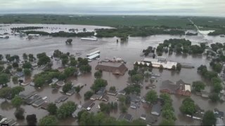 Gov. Kim Reynolds sent helicopters to the small town to evacuate people from flooded homes Saturday, the result of weeks of rain, while much of the United States longed for relief from yet another round of extraordinary heat.