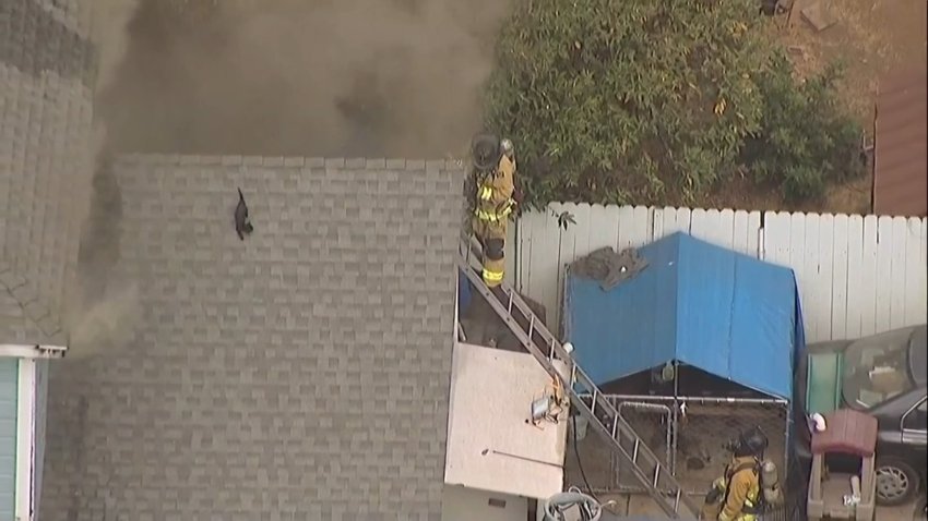 Firefighters attempted to save a cat from the roof of a burning house while at the same time putting out the flames in the South Bay on June 26, 2024. (SkyRanger7/NBC 7 San Diego)