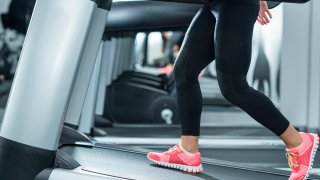 Detail from treadmill in the gym. Selective focus on human les.