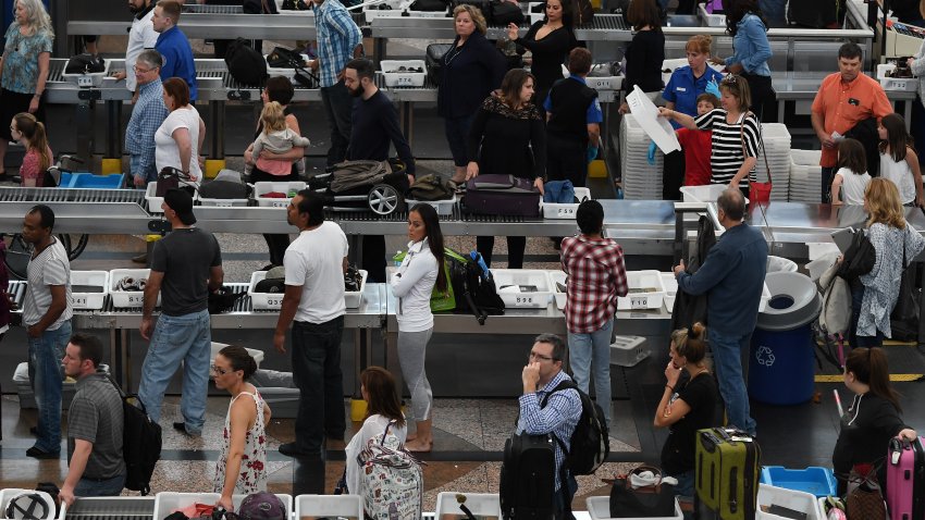 Travelers, at Denver International Airport, make there way through security lines as people start traveling for the long Memorial Day weekend, May 26, 2016.