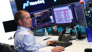 Analysts working at the Nasdaq.