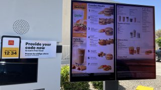 The drive-thru menu at a McDonald’s restaurant showing various meal options and promotions, in Buttonwillow in Kern County, California, on 23, 2024.