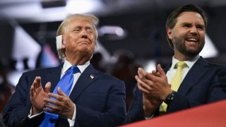 Republican presidential nominee and former U.S. President Donald Trump and Republican vice presidential nominee J.D. Vance applaud on Day 2 of the Republican National Convention (RNC), at the Fiserv Forum in Milwaukee, Wisconsin, U.S., July 16, 2024. 