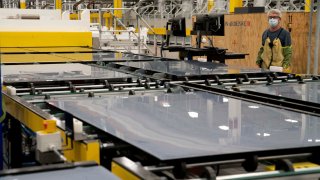 Chuck Smith monitors the manufacturing process of the series 6 solar panels during a tour of a First Solar plant in Walbridge, Ohio, on Oct. 6, 2021.