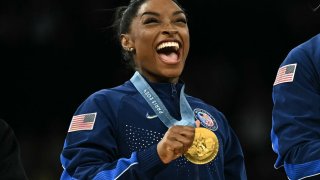 US’ Simone Biles poses with the gold medal during the podium ceremony for the artistic gymnastics women’s team final during the Paris 2024 Olympic Games at the Bercy Arena in Paris, on July 30, 2024. 