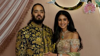 Anant Ambani, left, and Radhika Merchant pose for photographers during their pre-wedding ceremony in Mumbai.