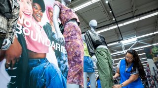 A Walmart’s staff member works on a display of the No Boundaries collection at a store in Secaucus, New Jersey, Thursday, July 11, 2024. The Bentonville, Arkansas-based retailer has revamped its 30-year-old mainstay store brand for young adults called No Boundaries, which generates annual sales of $2 billion.