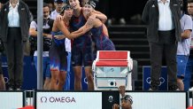 Silver medallists US' Kate Douglass, US' Gretchen Walsh, US' Torri Huske and US' Simone Manuel react after competing in the final of the women's 4x100m freestyle relay swimming event at the Paris 2024 Olympic Games at the Paris La Defense Arena in Nanterre, west of Paris, on July 27, 2024. (Photo by Jonathan NACKSTRAND / AFP) (Photo by JONATHAN NACKSTRAND/AFP via Getty Images)