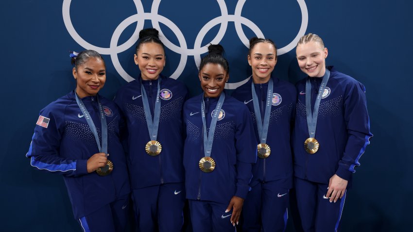 Team USA women's gymnastics poses with medals