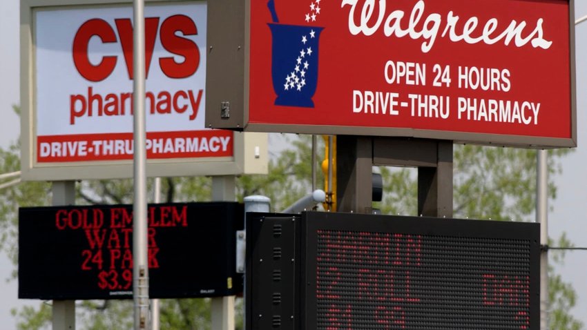 A Walgreens and CVS drugstore are seen on adjacent corners at an intersection in Calumet City, Ill.