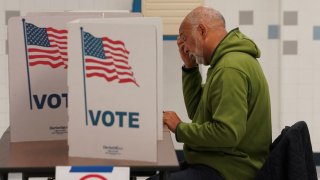 A voter fills out a ballot at a polling station on Election Day in Falls Church, Virginia, U.S., November 7, 2023.