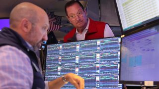 Traders work on the floor of the New York Stock Exchange during morning trading on August 06, 2024 in New York City. 