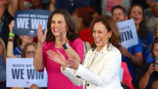 Vice President and Democratic presidential candidate Kamala Harris (R) and Michigan Gov. Gretchen Whitmer (L) stand together on the stage surrounded by supporters campaign rally at the Detroit Metropolitan Airport in Romulus, Michigan, August 7, 2024. 