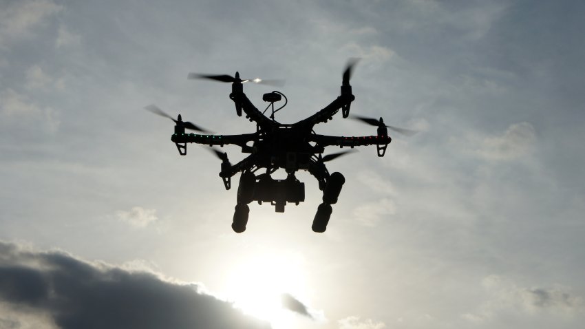 Hexacopter taking aerial photos at sunset. Also known as a drone or UAV (Unmanned Aerial Vehicle).