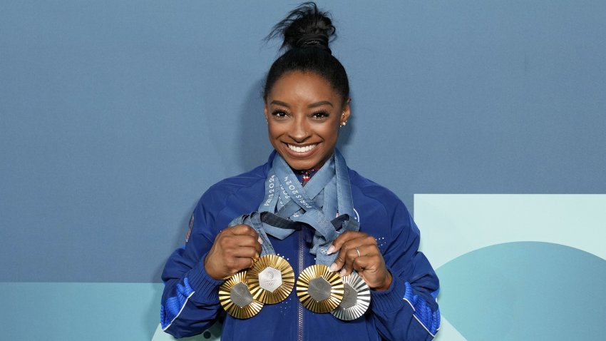 Simone Biles of the United States poses for a photo with her three gold and one silver medal after day three of the gymnastics event finals during the Paris 2024 Olympic Summer Games. Mandatory Credit: Kyle Terada-USA TODAY Sports