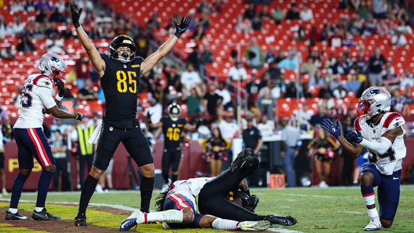 Cole Turner #85 of the Washington Commanders celebrates after Martavis Bryant #88 scores a touchdown against the New England Patriots during the fourth quarter of the preseason game at Commanders Field on Aug. 25, 2024 in Landover, Maryland.