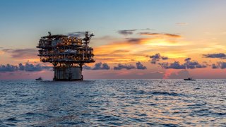 Private fishing boats near offshore petroleum drilling rig in the Gulf of Mexico. 