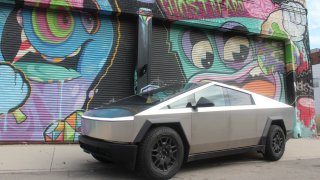 A Tesla Cybertruck in front of a graffiti mural on Aug. 28, 2024 in Detroit.