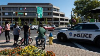 People watch as Springfield Police Department officers investigate the Springfield City Hall after bomb threats were made against buildings earlier in the day in Springfield, Ohio, on Sept. 12, 2024.