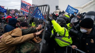 WASHINGTON, DC – JANUARY 06: Pro-Trump supporters clash with law enforcement on the west steps/inauguration stage of the U,S. Capitol as people gathered on the second day of pro-Trump events fueled by President Donald Trump’s continued claims of election fraud in an to overturn the results before Congress finalizes them in a joint session of the 117th Congress on Wednesday, Jan. 6, 2021 in Washington, DC. (Kent Nishimura / Los Angeles Times via Getty Images)