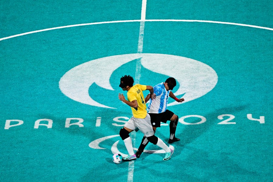 Brazil's Maicon Junior dos Santos Mendes fights for the ball with Argentina's Maximiliano Espinillo during the blind football men's semifinal match between Brazil and Argentina of the Paris 2024 Paralympic Games at the Eiffel Tower Stadium in Paris on September 5 2024