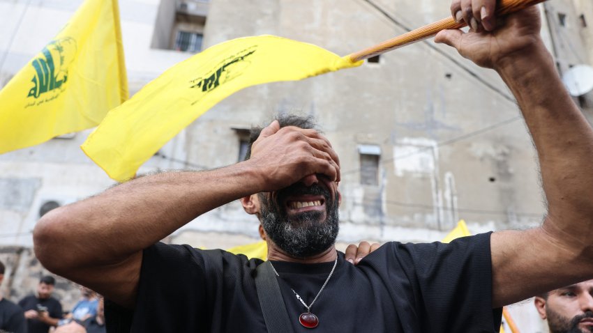 A man attends the funeral of people killed after hundreds of paging devices exploded in a deadly wave across Lebanon the previous day, in a south Beirut district, on Wednesday.