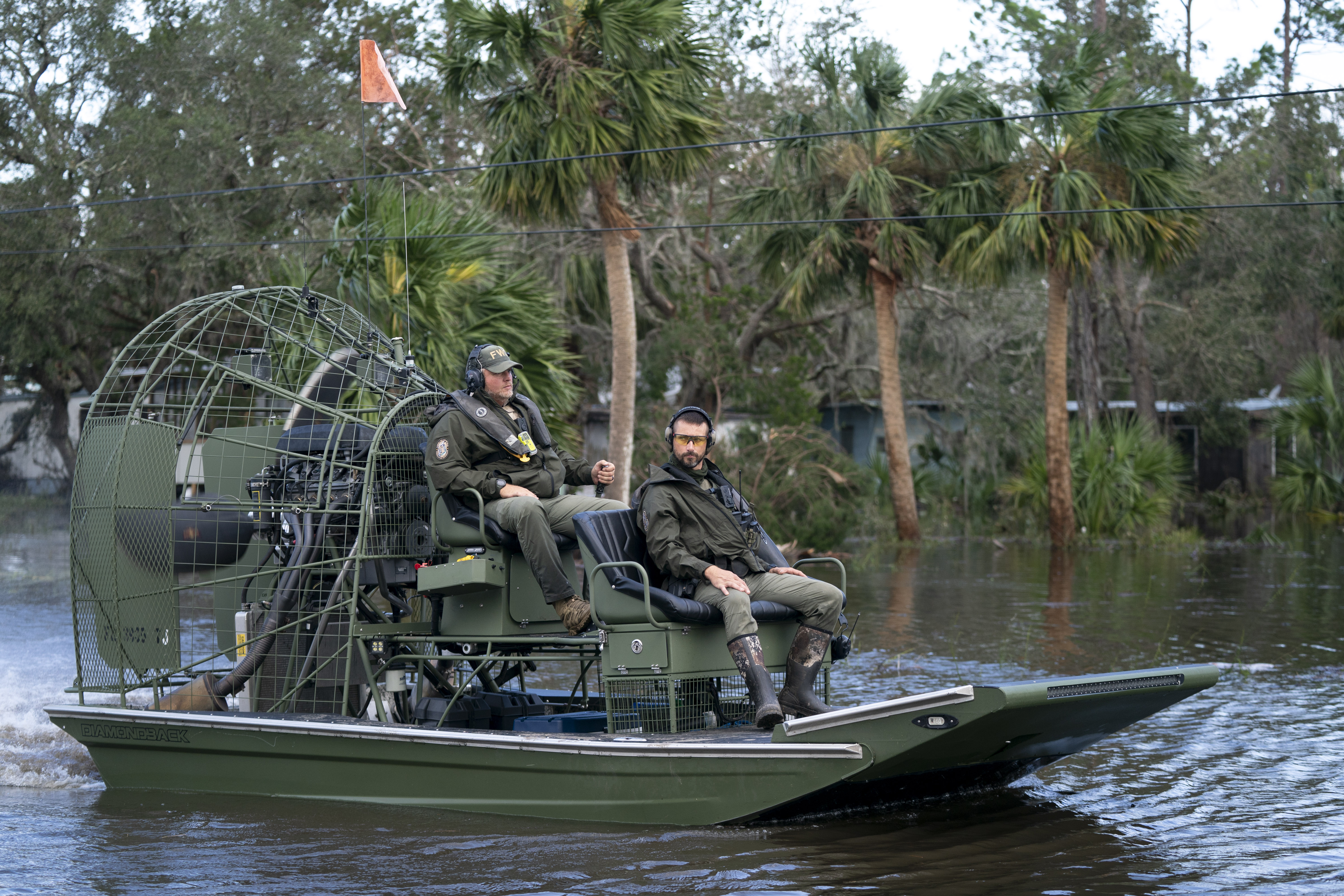 Florida Fish and Wildlife Conservation Commission officers operate an airboat on a flooded street in the aftermath of Hurricane Helene on September 27, 2024 in Steinhatchee, Florida.