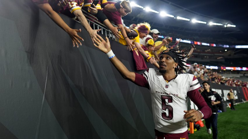 CINCINNATI, OHIO – SEPTEMBER 23: Jayden Daniels #5 of the Washington Commanders celebrates with fans after defeating the Cincinnati Bengals in the game at Paycor Stadium on September 23, 2024 in Cincinnati, Ohio. (Photo by Dylan Buell/Getty Images)