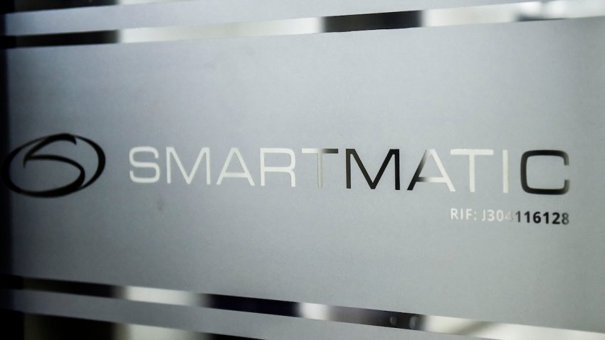 Picture of the logo of Smartmatic, the firm that supplies Venezuela’s voting technology, seen on a sliding door at the headquarters of the company in Caracas, on Aug. 2, 2017. – Smartmatic said official figures in Sunday’s election of the new super-assembly, with candidates selected from the ruling party, were “tampered with” in such a way that the turnout appeared greater than it was. Venezuela’s President Nicolas Maduro moved quickly Wednesday to swear in a new assembly with extraordinary powers as he faced charges that turnout figures for the body’s election were “manipulated.”