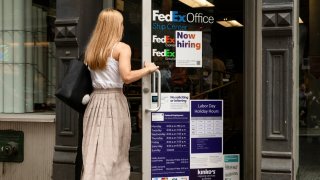 A “Now Hiring” sign on a FedEx Office Ship Center in New York, US, on Friday, Aug. 9, 2024.