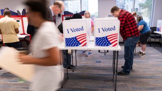 Voters work on their ballot at a polling station at the Elena Bozeman Government Center in Arlington, Virginia, on September 20, 2024.