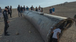 People inspect remains of a missile on October 2, 2024 in Arad, Israel. 