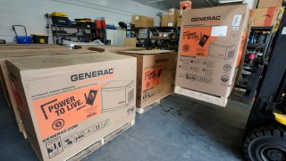 A worker unloads a 24-kilowatt Generac home generator off a truck at Captain Electric on February 18, 2021 in Orem, Utah. The company has had a surge in the purchase and installation of home generators over the last several months and currently has a four-month backlog of orders.  (Photo by George Frey/Getty Images)