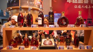 HAIKOU, CHINA – DECEMBER 17: People purchase brandies during the 26th China (Hainan) International Winter Trade Fair for Tropical Agricultural Products at Hainan International Convention And Exhibition Center on December 17, 2023 in Haikou, Hainan Province of China. 