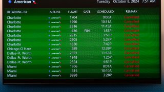 A message board at the Tampa International Airport shows all American Airlines departing flight canceled Tuesday, Oct. 8, 2024, in Tampa, Fla., due to the possible arrival of Hurricane Milton.